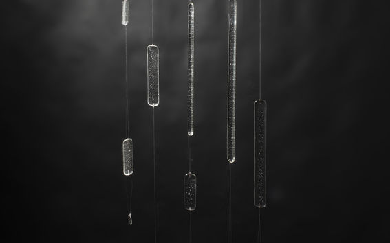 Pieces of glass hanging from the ceiling, an art work by Sesilia Pirttimaa, for honoring the donators for the School of Arts, Design and Architecture